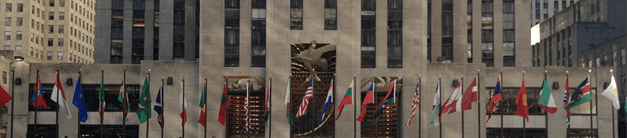 The flags of many nations flying at Rockefeller Center